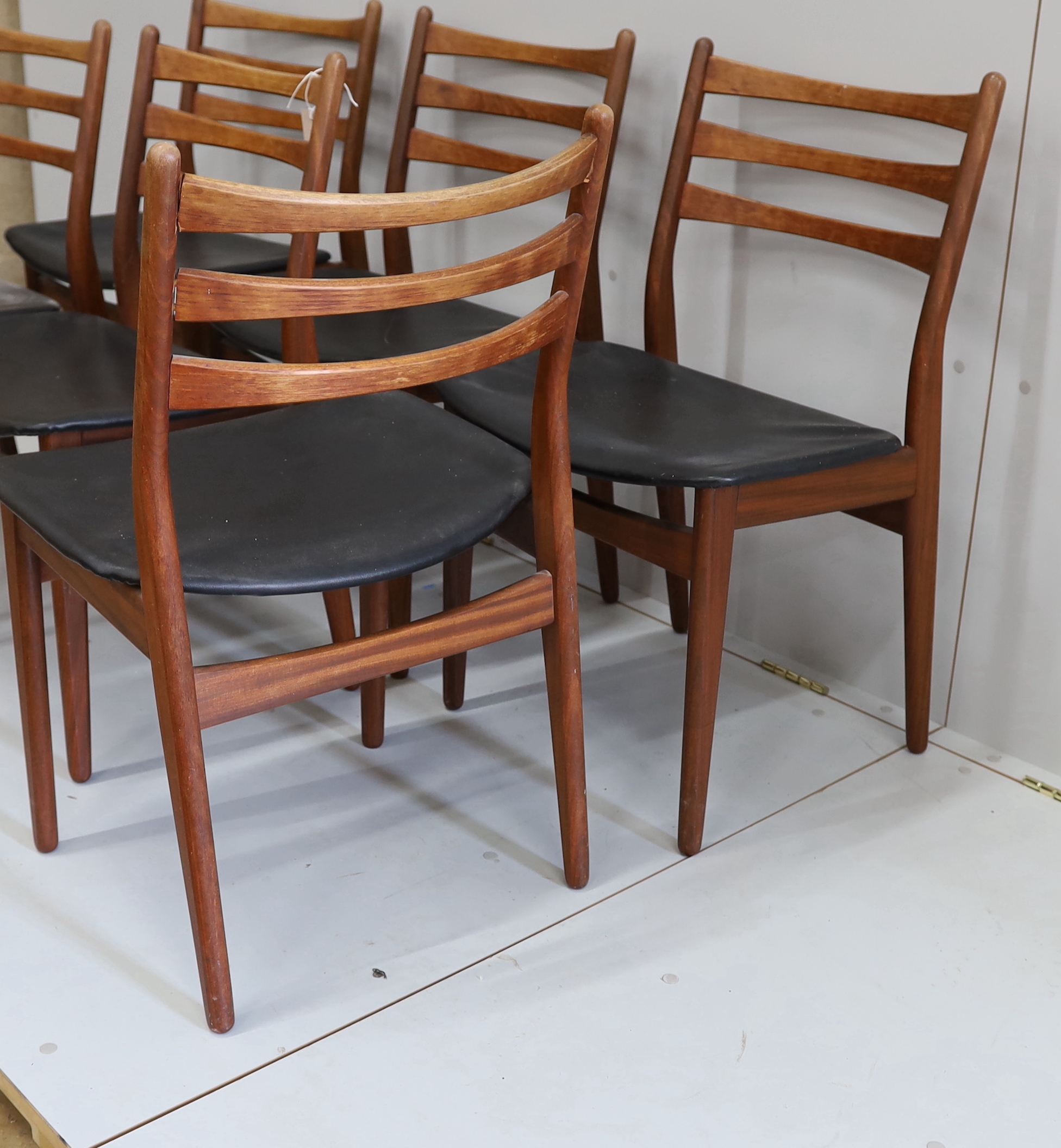 A set of six mid century, Danish design, teak and black leatherette dining chairs, width 50cm, depth 40cm, height 80cm